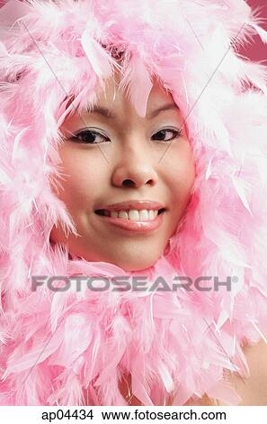 Woman with pink feathers around her face View Large Photo Image Picture - Woman with pink feathers around her face. Fotosearch