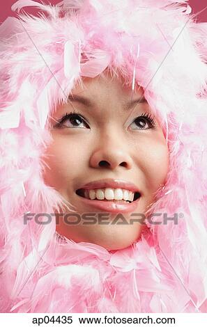 Woman with pink feathers around her face, looking up View Large Photo Image Stock Photography - Woman with pink feathers around her face, looking up. Fotosearch