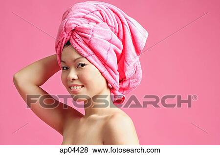 Woman with pink towel wrapped around her head View Large Photo Image Stock Photo - Woman with pink towel wrapped around her head. Fotosearch