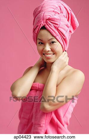 Woman wrapped in a pink towel, wearing pink turban View Large Photo Image Stock Image - Woman wrapped in a pink towel, wearing pink turban. Fotosearch