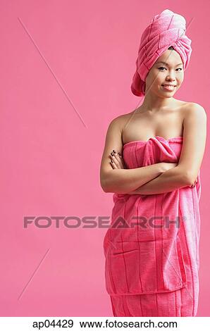 Woman wrapped in a pink towel, wearing pink turban, arms crossed View Large Photo Image Stock Photo - Woman wrapped in a pink towel, wearing pink turban, arms crossed. Fotosearch