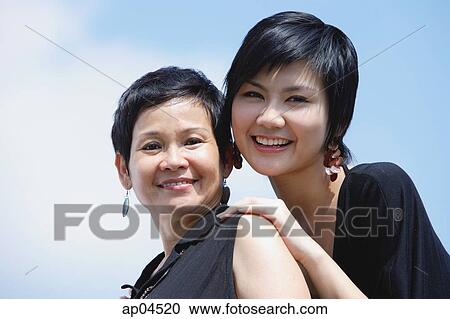Women side by side, smiling, looking at camera View Large Photo Image Stock Image - Women side by side, smiling, looking at camera. Fotosearch