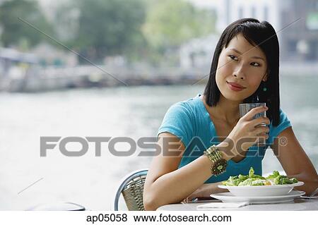 Young woman in cafe, looking away View Large Photo Image Stock Photo - Young woman in cafe, looking away. Fotosearch