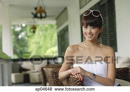 Young woman in white tube top, smiling at camera View Large Photo Image Stock Photo - Young woman in white tube top, smiling at camera. Fotosearch