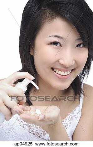 Young woman putting moisturizer on hand View Large Photo Image Stock Photography - Young woman putting moisturizer on hand. Fotosearch