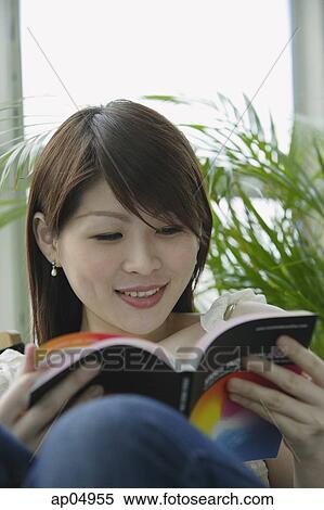 Young woman reading a book View Large Photo Image Stock Photography - Young woman reading a book. Fotosearch