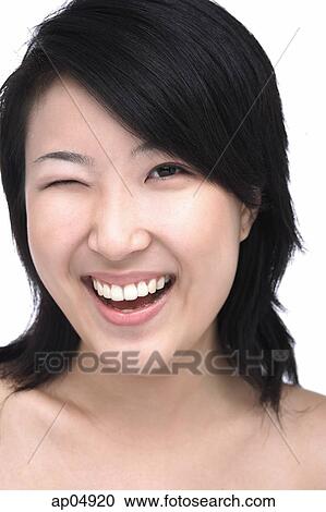 Stock Image - Young woman winking. Fotosearch