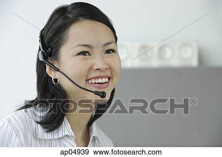 Young woman with hands free device, smiling, portrait View Large Photo Image Stock Photo - Young woman with hands free device, smiling, portrait. Fotosearch