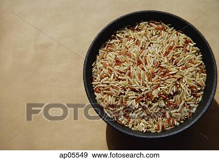 Bowl with uncooked rice View Large Photo Image Stock Photo - Bowl with uncooked rice. Fotosearch