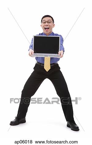 Businessman carrying laptop, portrait View Large Photo Image Stock Photo - Businessman carrying laptop, portrait. Fotosearch