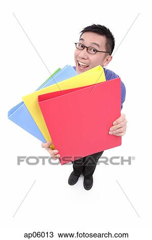 Stock Image - Businessman carrying multi coloured folders. Fotosearch