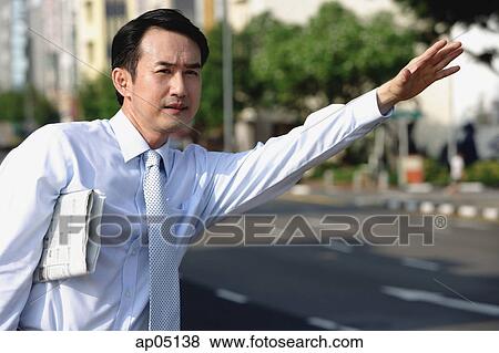 Businessman flagging a cab View Large Photo Image Stock Photo - Businessman flagging a cab. Fotosearch