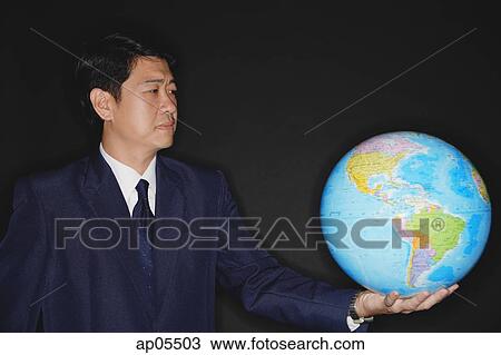 Businessman holding globe View Large Photo Image Stock Image - Businessman holding globe. Fotosearch