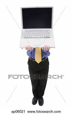 Businessman holding laptop over his face View Large Photo Image Stock Image - Businessman holding laptop over his face. Fotosearch