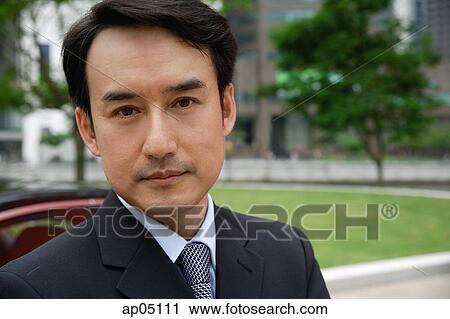 Businessman looking at camera, portrait View Large Photo Image Stock Image - Businessman looking at camera, portrait. Fotosearch