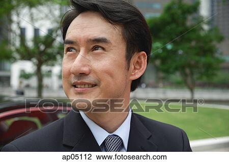 Businessman looking away, head shot View Large Photo Image Stock Image - Businessman looking away, head shot. Fotosearch