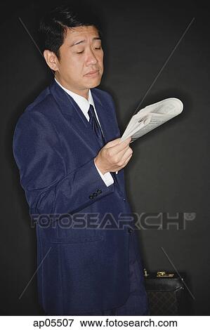 Stock Photo - Businessman reading newspaper. Fotosearch