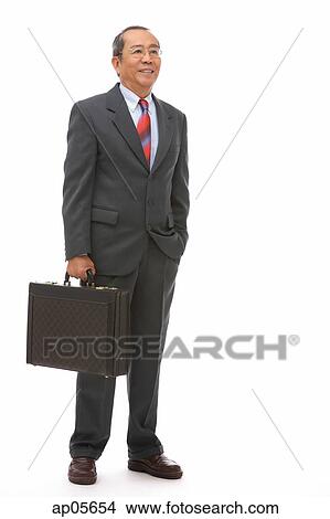 Businessman standing with briefcase View Large Photo Image Picture - Businessman standing with briefcase. Fotosearch