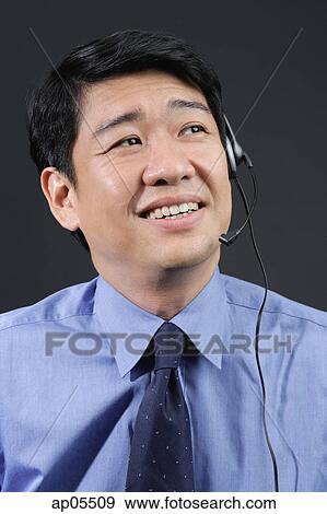 Businessman using hands free device View Large Photo Image Stock Photo - Businessman using hands free device. Fotosearch