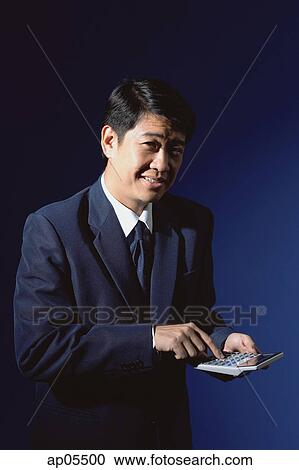 Stock Image - Businessman with calculator. Fotosearch