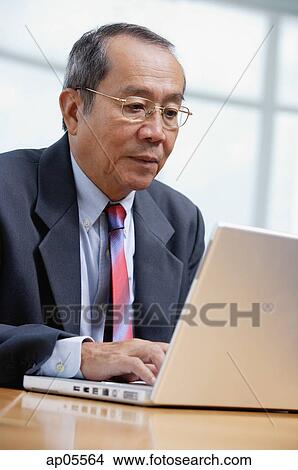 Businessman with laptop View Large Photo Image Picture - Businessman with laptop. Fotosearch