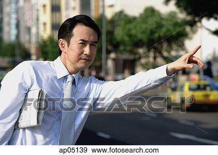Businessman with newspaper under his arm, flagging a cab View Large Photo Image Stock Photo - Businessman with newspaper under his arm, flagging a cab. Fotosearch