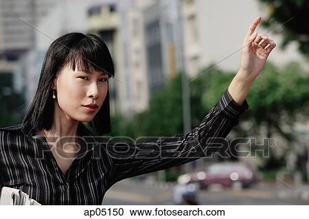 Businesswoman flagging a cab View Large Photo Image Stock Image - Businesswoman flagging a cab. Fotosearch
