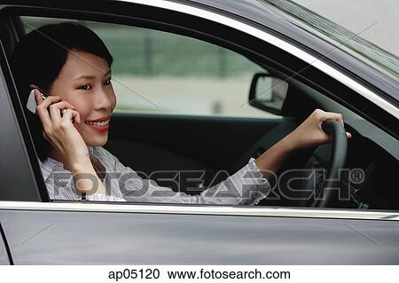 Businesswoman in car using mobile phone View Large Photo Image Stock Image - Businesswoman in car using mobile phone. Fotosearch