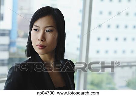 Stock Image - Businesswoman looking away, head shot. Fotosearch