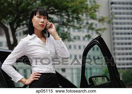 Businesswoman using mobile phone View Large Photo Image Stock Photography - Businesswoman using mobile phone. Fotosearch