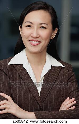Businesswoman with arms crossed, smiling View Large Photo Image Stock Image - Businesswoman with arms crossed, smiling. Fotosearch