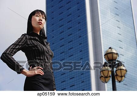 Businesswoman with hand on hip, looking away View Large Photo Image Stock Photo - Businesswoman with hand on hip, looking away. Fotosearch