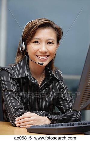 Businesswoman with hands free device, arms crossed View Large Photo Image Stock Photography - Businesswoman with hands free device, arms crossed. Fotosearch