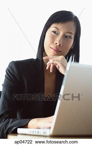 Businesswoman with laptop, looking away, hand on chin View Large Photo Image Stock Image - Businesswoman with laptop, looking away, hand on chin. Fotosearch