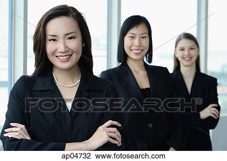 Businesswomen in a row, smiling at camera View Large Photo Image Stock Image - Businesswomen in a row, smiling at camera. Fotosearch