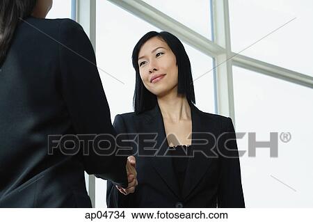 Picture - Businesswomen shaking hands. Fotosearch