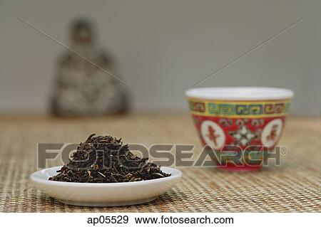 Chinese teacup and plate of tea leaves, still life View Large Photo Image Stock Photo - Chinese teacup and plate of tea leaves, still life. Fotosearch