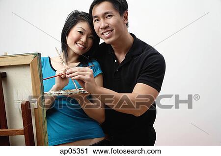 Couple at home, standing in front of easel with palette and paint brushes View Large Photo Image Stock Image - Couple at home, standing in front of easel with palette and paint brushes. Fotosearch