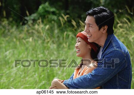 Couple embracing, looking away View Large Photo Image Stock Photography - Couple embracing, looking away. Fotosearch