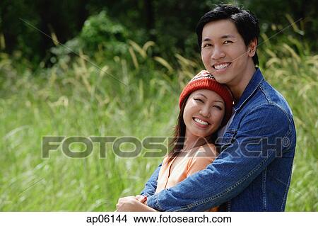 Couple embracing, smiling at camera, portrait View Large Photo Image Picture - Couple embracing, smiling at camera, portrait. Fotosearch