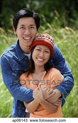 Couple embracing, smiling at camera View Large Photo Image Stock Image - Couple embracing, smiling at camera. Fotosearch