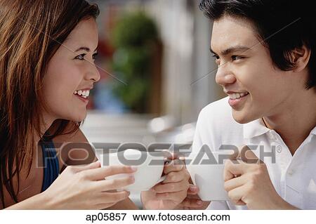 Couple in cafe having coffee, face to face View Large Photo Image Stock Photo - Couple in cafe having coffee, face to face. Fotosearch