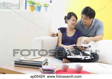 Couple in living room View Large Photo Image Picture - Couple in living room. Fotosearch