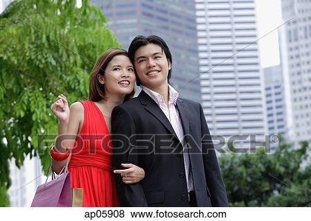 Couple in the city, woman carrying shopping bags View Large Photo Image Stock Photo - Couple in the city, woman carrying shopping bags. Fotosearch
