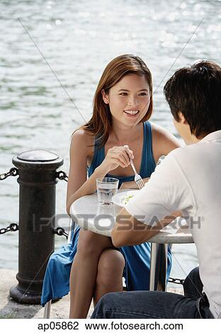 Couple sitting at outdoor cafe View Large Photo Image Stock Image - Couple sitting at outdoor cafe. Fotosearch