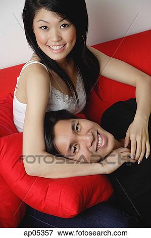 Couple smiling at camera, man lying on woman's lap View Large Photo Image Stock Photo - Couple smiling at camera, man lying on woman's lap. Fotosearch