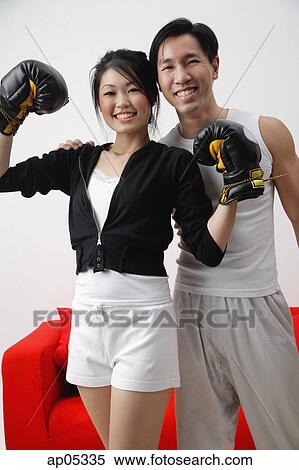 Couple smiling at camera, woman with boxing gloves View Large Photo Image Stock Photography - Couple smiling at camera, woman with boxing gloves. Fotosearch