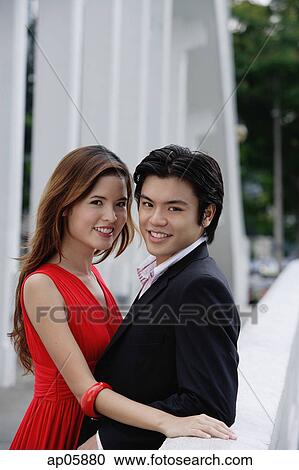 Couple standing cheek to cheek, looking at camera View Large Photo Image Stock Image - Couple standing cheek to cheek, looking at camera. Fotosearch