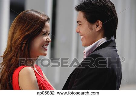 Couple standing face to face, smiling View Large Photo Image Stock Image - Couple standing face to face, smiling. Fotosearch
