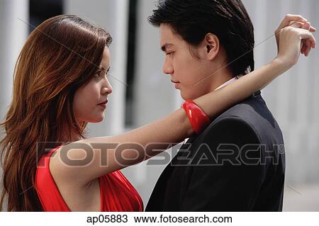 Stock Image - Couple standing face to face. Fotosearch